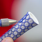 Rhian Malin decorating a mandala bottle in her workshop 2019